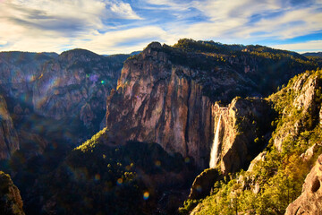 amazing canyon with waterfall in the background and dramatic sky in sierra tarahumara, basaseachi...