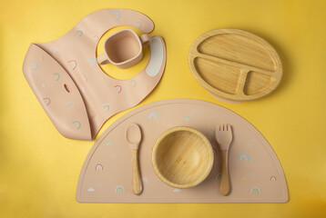 A set of children's silicone dishes. Baby feeding and nutrition concept. Top view, flat lay.