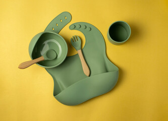 A set of children's silicone dishes. Baby feeding and nutrition concept. Top view, flat lay.