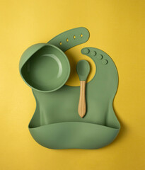 A set of children's silicone dishes. Baby feeding and nutrition concept. Top view, flat lay.
