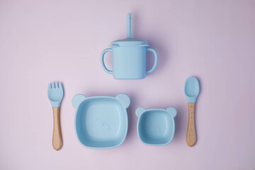 A set of children's silicone dishes. Baby feeding and nutrition concept. Top view, flat lay.