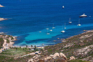 Obraz premium Tropical bay with sailing boats at the french island Corsica in the mediterranean sea