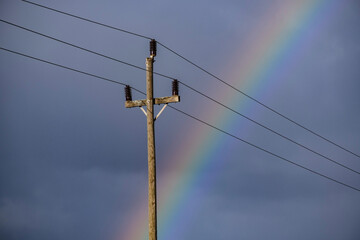 Obraz premium old electric pole with the rainbow behind, Majorca, Balearic Islands, Spain