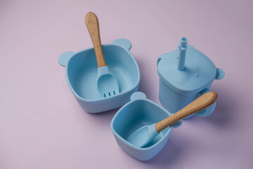 A set of children's silicone dishes. Baby feeding and nutrition concept. Top view, flat lay.