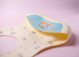 Details of a silicone bib for babies. Baby feeding and nutrition concept. Top view, flat lay. Close-up.