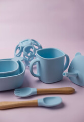 A set of children's silicone dishes. Baby feeding and nutrition concept. Top view, flat lay.