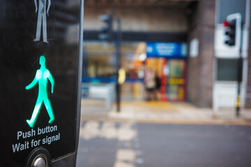 green figure of a man on a crossing point to indicate to pedestrians that it is safe to cross the...
