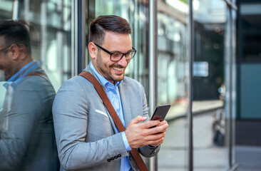 Good news. Happy smiling businessman checking mail from his client on smartphone. Business, lifestyle concept