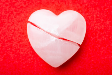 Close up of broken heart. Stone in shape of a heart broken in the middle, concept of broken heart, separation