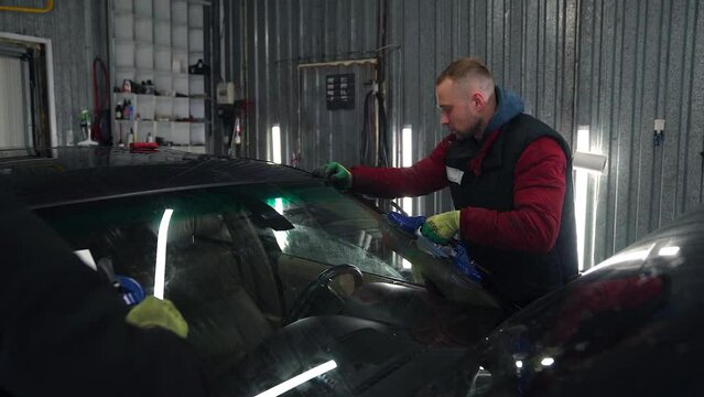 Guys Trying New Windshield On Car .Slow Motion.
