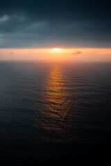 Obraz premium drone view of the ocean and the sun hidden in the clouds