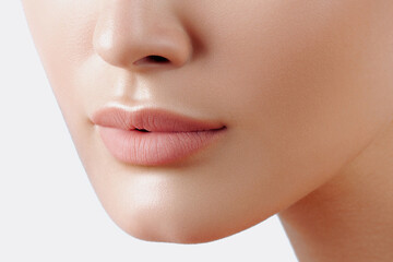 Obraz premium Lips of young beautiful woman closeup. Clean skin, nude makeup