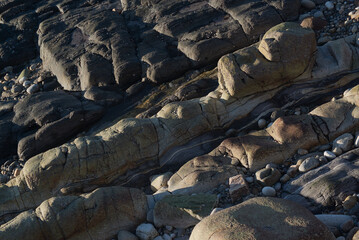 Stone rocks deformed by waves on the seashore