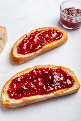 Open Sandwich with toasted sourdough white bread slices and raspberry jam