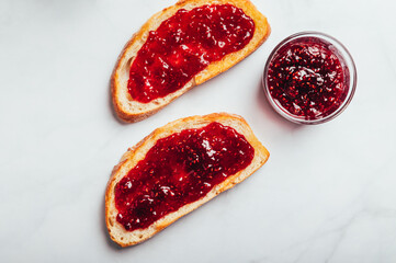 Open Sandwich with toasted sourdough white bread slices and raspberry jam