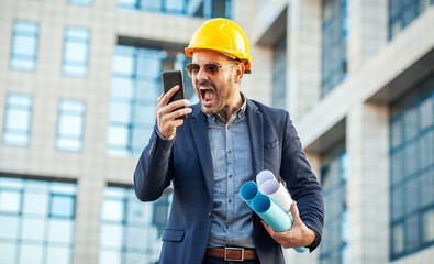 Something is wrong on building site. Angry architect yelling on head of the construction site while...