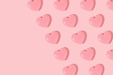 Valentines day creative pattern with baby pink hearts on pastel pink background. 80s or 90s retro fashion aesthetic love concept. Minimal romantic idea with copy space.