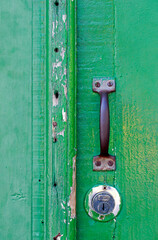 Lock and knob in closed green antique door in Santana do Parnaiba, colonial city in State of Sao Paulo, Brazil