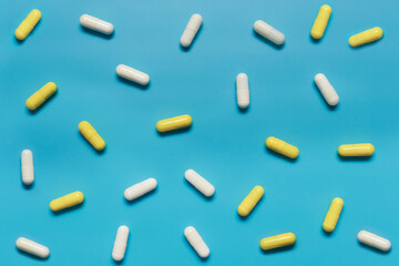 Pharmacy background. Pills and capsules on a blue background. Drugs are used to treat and treat a disease. Medicine, pharmacy and healthcare concept, medicine in medical clinic, flat lay.
