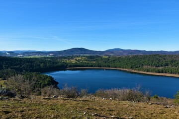 View of Petelinjsko jezero lake in Notranjska, Slovenia and the town of Pivka