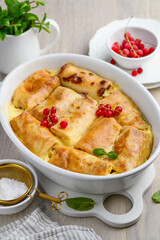 Baked crepes with cottage cheese or ricotta in cream, decorated berries and mint. Healthy breakfast. Selective focus