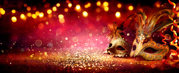 Carnival Party - Venetian Masks On Red Glitter With Shiny Streamers On Abstract Defocused Bokeh...