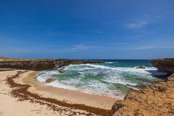 Gorgeous  view of big turquoise waves Atlantic ocean on western rocky coast of island of Aruba.