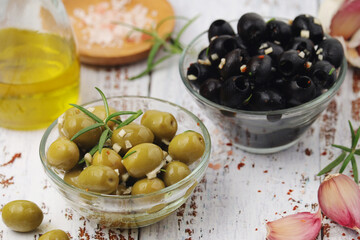 Black and green olives in glass bowls	