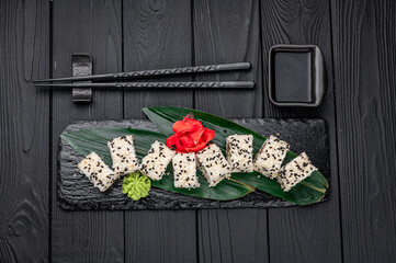Traditional Japanese cuisine maki sushi rolls with salmon, avocado, cream cheese and sesame.