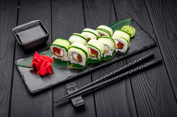 Sushi roll with salmon and cream cheese wrapped in cucumber