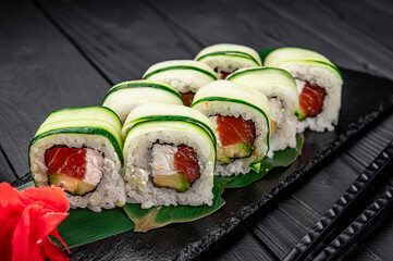 Sushi roll with salmon and cream cheese wrapped in cucumber