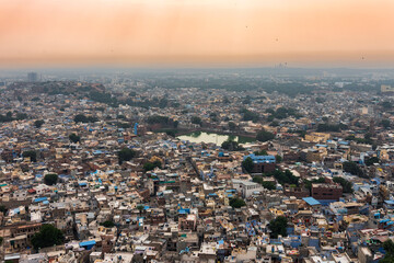 Aerial view of blue city, Jodhpur, Rajasthan,India. Orange sky background. Resident Brahmins worship Lord Shiva and painted their houses in blue as blue is his favourite colour. Hence named blue city.