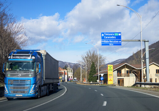 Volvo truck, goods carrier. Moving truck and road signs.Romania, Herculane. February, 02, 2023