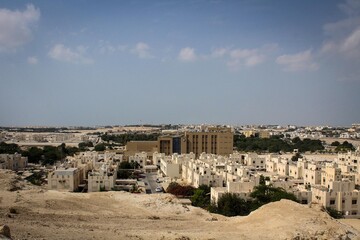 Fototapeta na wymiar Bright white residential houses near Riffa Fort in Bahrain