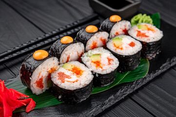 Sushi rolls with salmon, crab, shrimps and spicy sauce