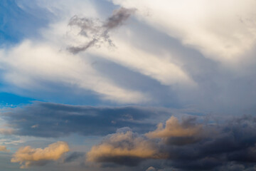 Impressive cloud structures with cirrus and cumulus haze in a blue sky on sunny day.