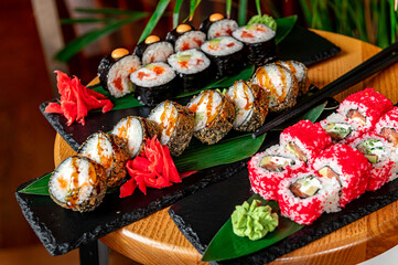 Big set of Asian food. Sushi and rolls on a dark background.