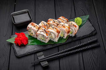 Sushi rolls japanese food on a dark background. Roll with eel