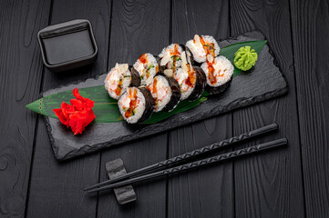 Sushi rolls with salmon, crab, shrimps and spicy sauce