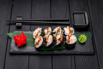 Sushi rolls with salmon, crab, shrimps and spicy sauce
