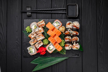 Big set of Asian food. Sushi and rolls on a dark background.