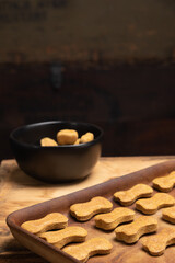 Homemade healthy dog treats on rustic wooden table.