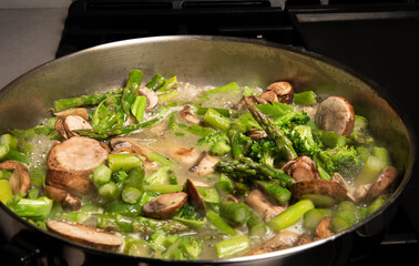 saute vegetales  in butter in pan