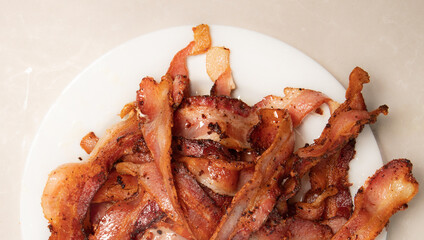 pile of bacon on white plate