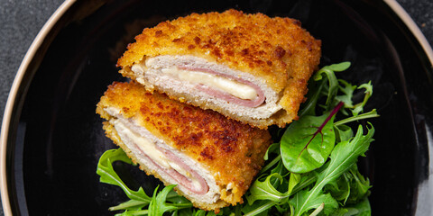 cordon bleu cutlet chicken meat, cheese, bacon meal snack on the table copy space food background...
