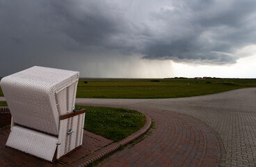 The photo shows a beach chair on the island of Baltrum in poor weather
