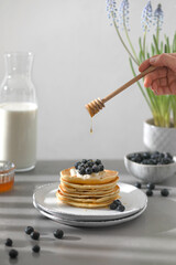 Pancakes with blue berries, ricotta and honey