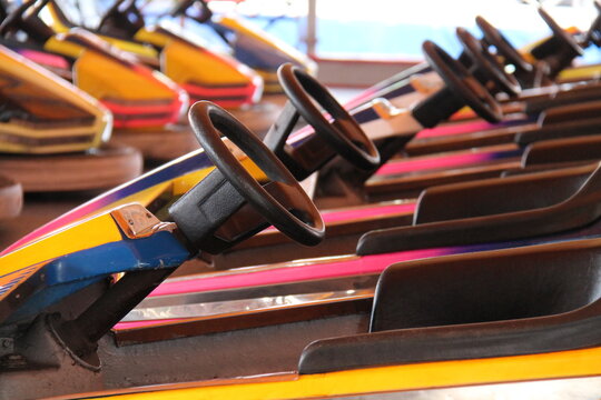 The Steering Wheels on a Row of Fun Fair Dodgem Cars.