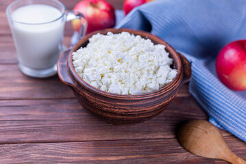dairy product cottage cheese in a plate on a wooden background