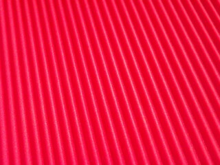 The corrugated surface is multicolored with parallel lines as a background black blue orange...
